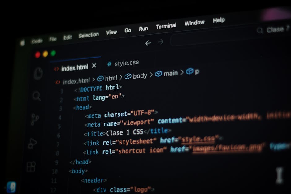 A close-up photograph of a computer screen displaying lines of HTML code, including elements such as <html>, <head>, and <body>, with visible tags like <title> and <link>. The code is highlighted with